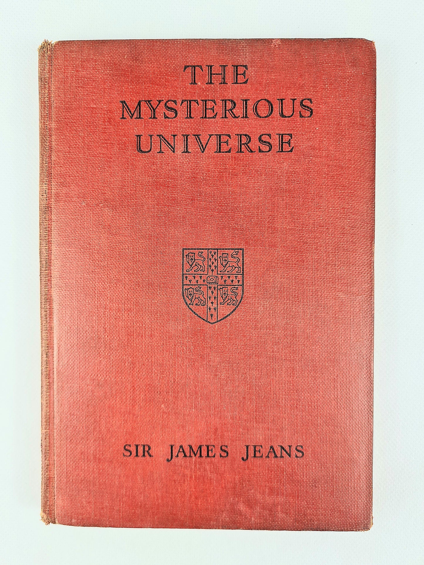 Red Hardback antique science book. The Mysterious Universe 