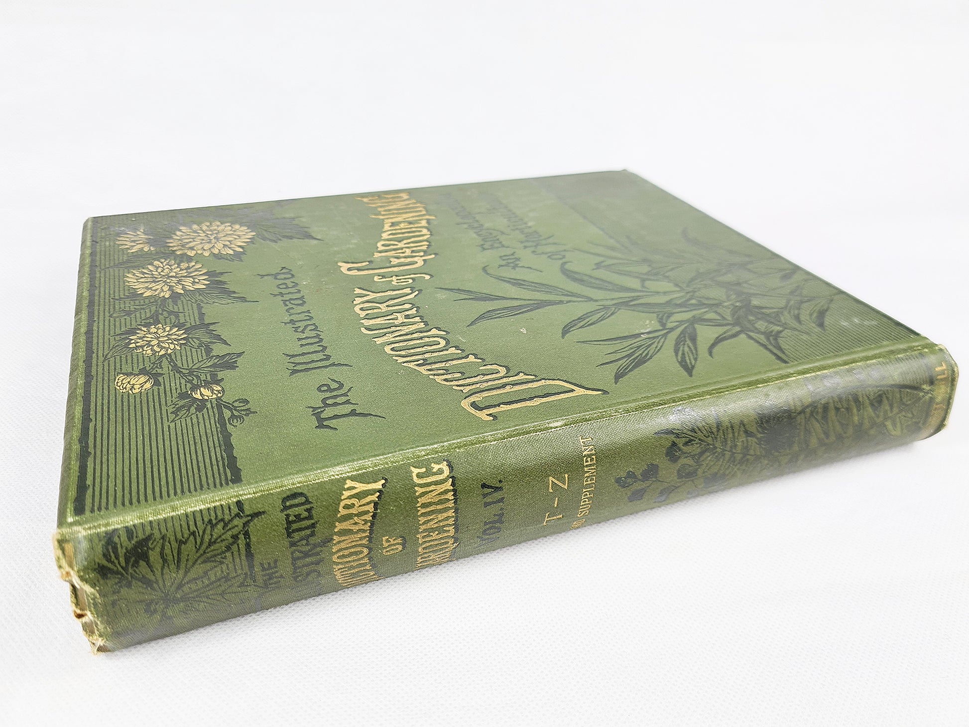 Vintage gardening book with a green and gold cover. Dictionary of Gardening 